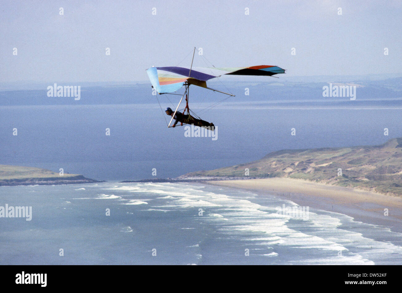 Hang glider gliding over Rhossili on Gower Peninsula in South Wales Uk Stock Photo