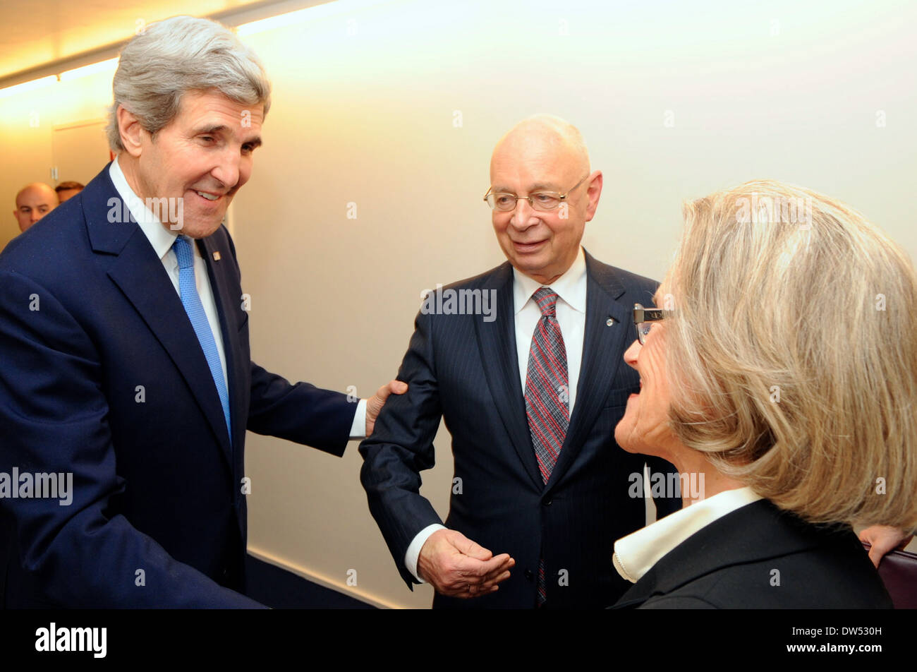 Secretary Kerry is Greeted by Klaus and Hilde Schaub at 2014 World Economic Forum Stock Photo