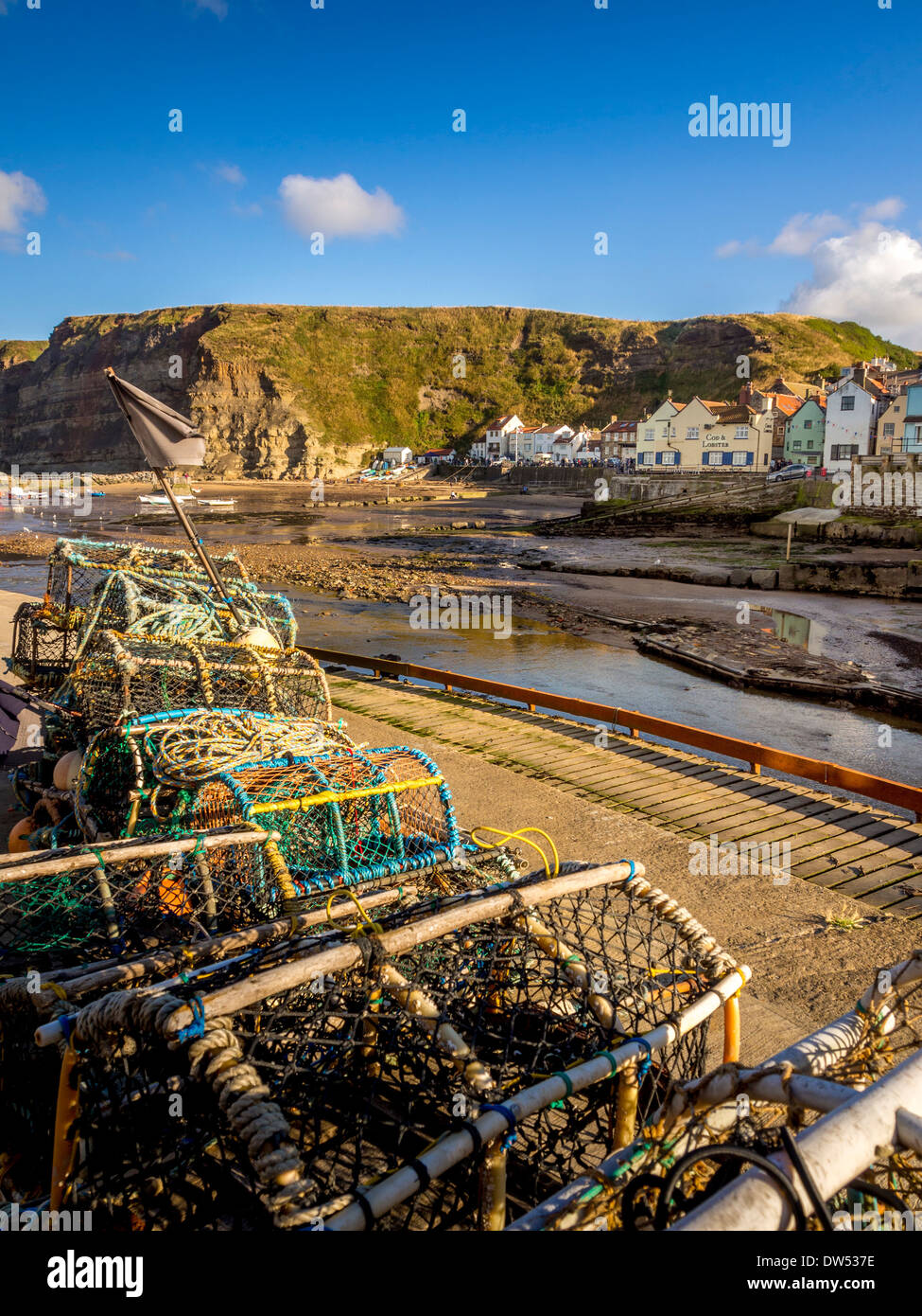 Stacked crab and lobster pots in the harbour of Staithes. North