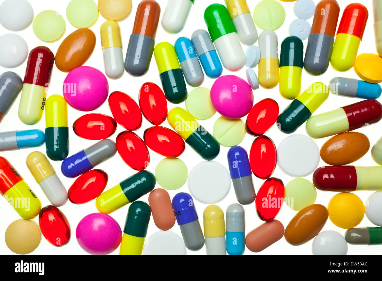 lots of multi-coloured assorted medicines drugs pills on a white background tablet tablets capsule capsules drug drugs pill pills Stock Photo