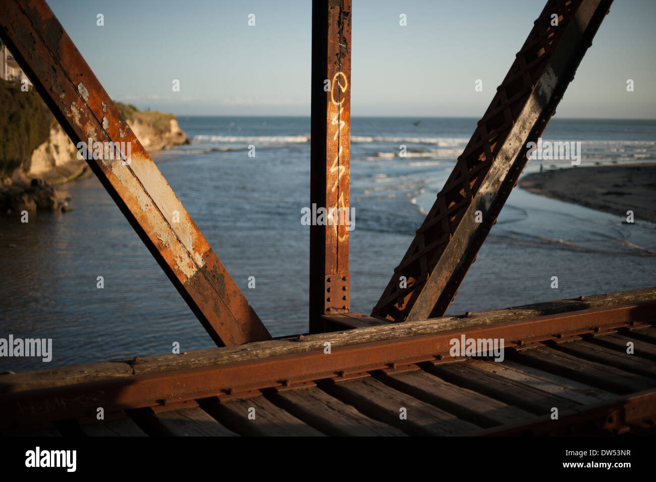 Old train bridge in Santa Cruz, CA at sunset overlooking the Pacific Ocean Stock Photo
