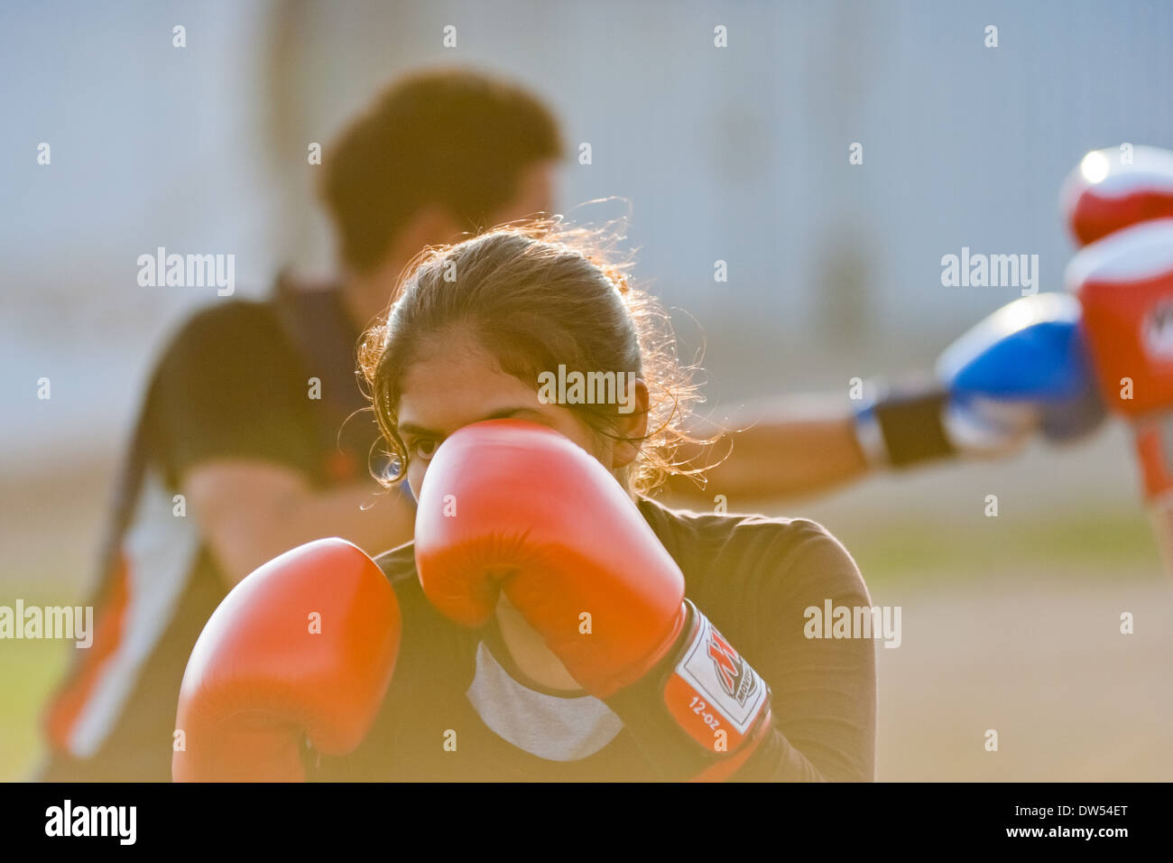 A Peruvian girl practices sparring while training in the outdoor boxing school at the Telmo Carbajo stadium in Callao, Peru. Stock Photo