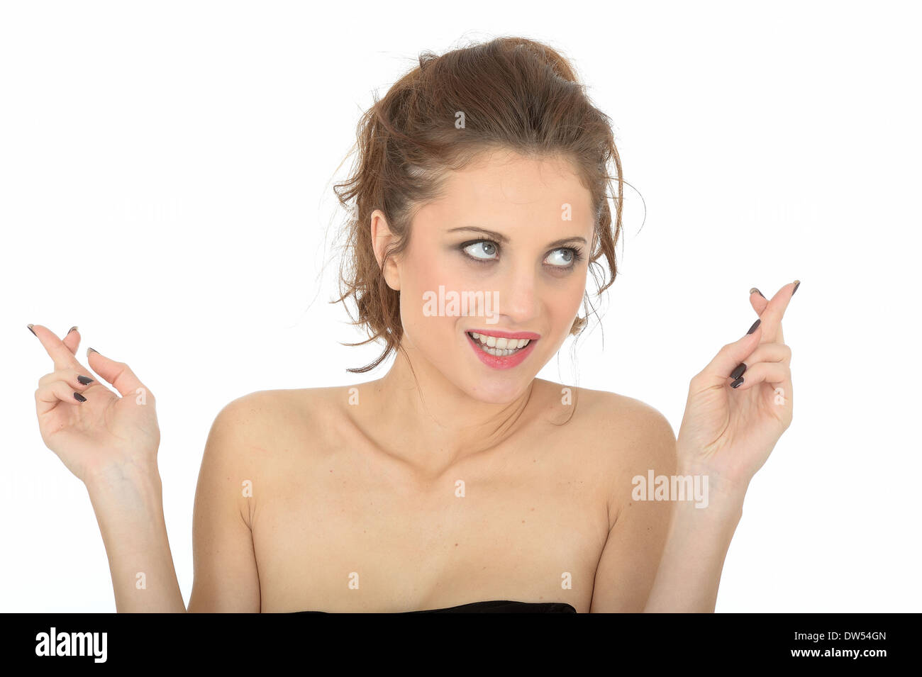 Hopeful Young Woman Fingers Crossed Stock Photo