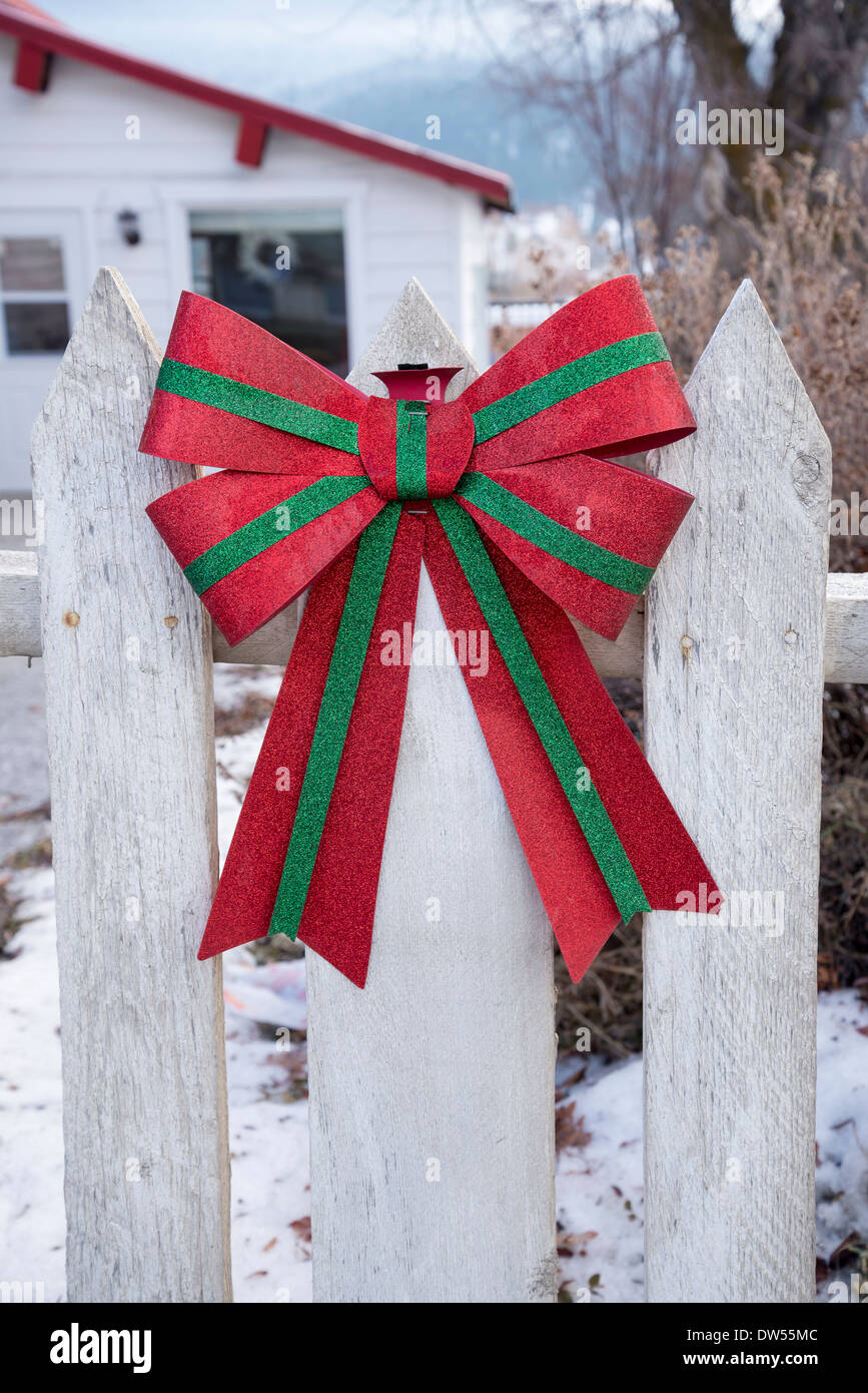 Festive bow on fence Stock Photo