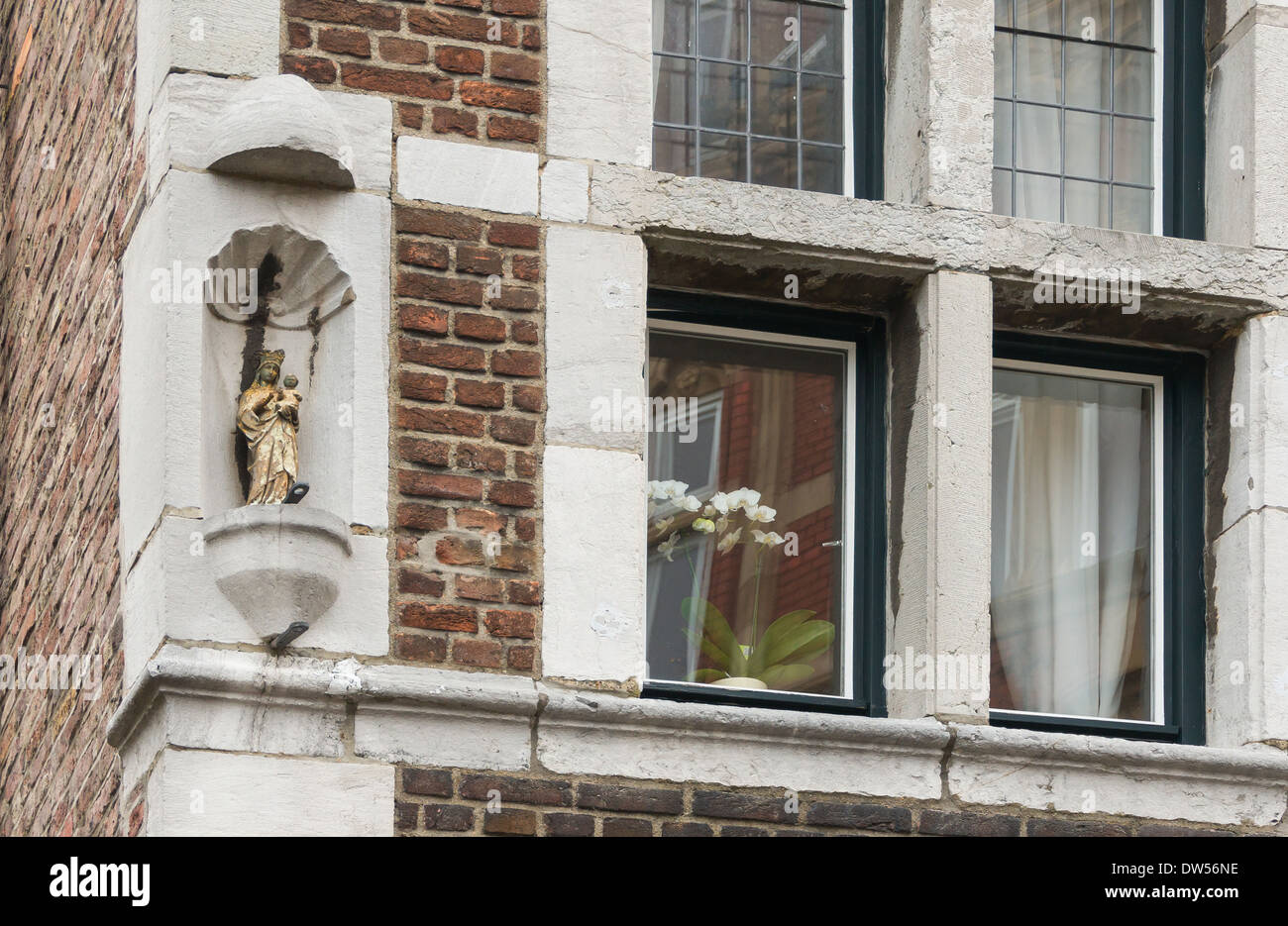 Statue of Virgin Mary in a niche, windows, Aachen, Germany. Stock Photo