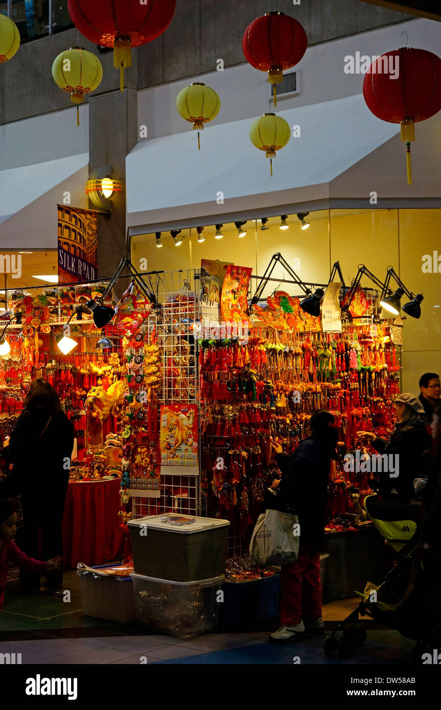 People shopping for traditional good luck charms at Chinese New Year celebrations in Chinatown, Vancouver, BC, Canada. Stock Photo