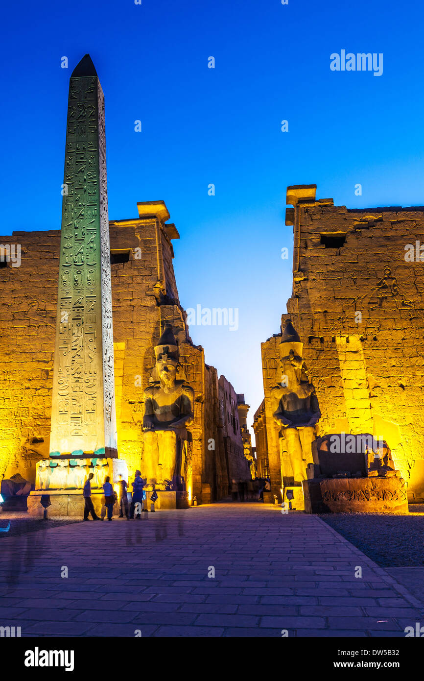 The obelisk and statues of Ramesses II at the entrance to Luxor Temple. Stock Photo