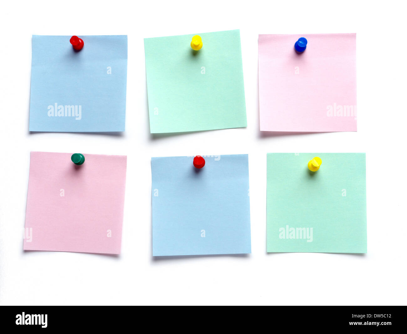 Six blank adhesive notes pinned on white surface Stock Photo