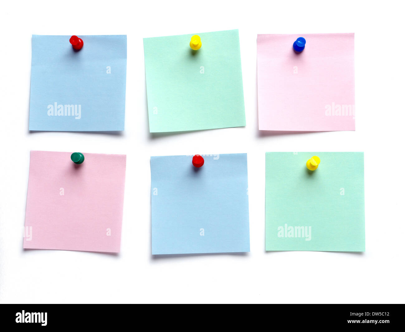 Six blank post-it notes pinned on white surface Stock Photo