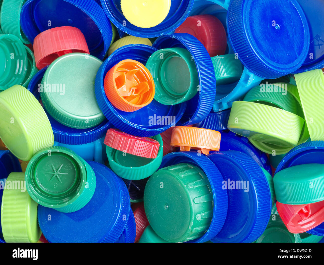 Background of assorted plastic tops and caps in different colors Stock Photo