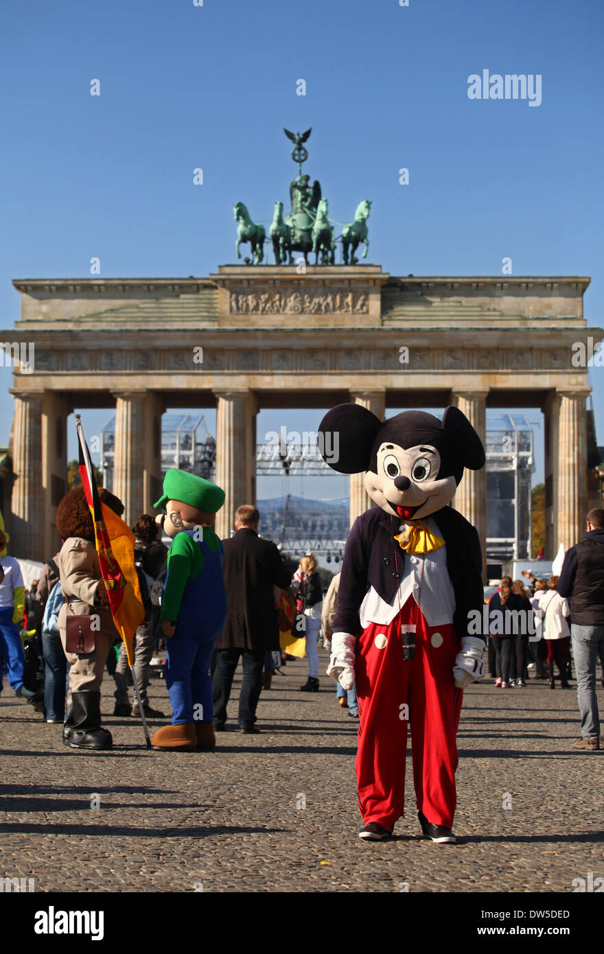 Men dressed up as different characters and Mickey Mouse wait for tourists at the Brandenburg Gate in Berlin, October, 03, 2013. More and more tourists come Berlin. The photo is part of a series on tourism in Berlin. Photo. Wolfram Steinberg dpa Stock Photo