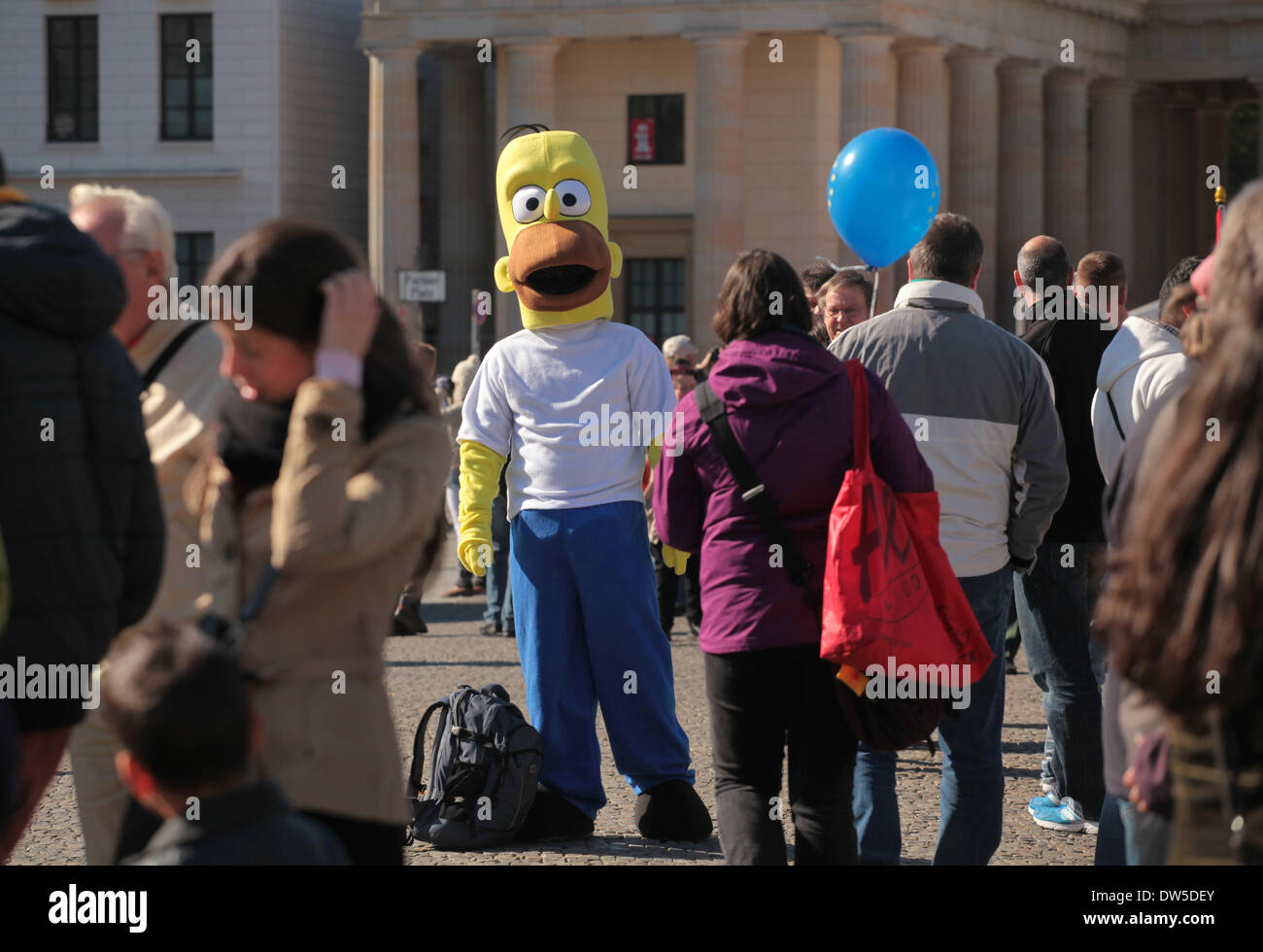 A man dressed up as Homer Simpson waits for tourists at the Brandenburg Gate in Berlin, October, 03, 2013. More and more tourists come Berlin. The photo is part of a series on tourism in Berlin. Photo. Wolfram Steinberg dpa Stock Photo