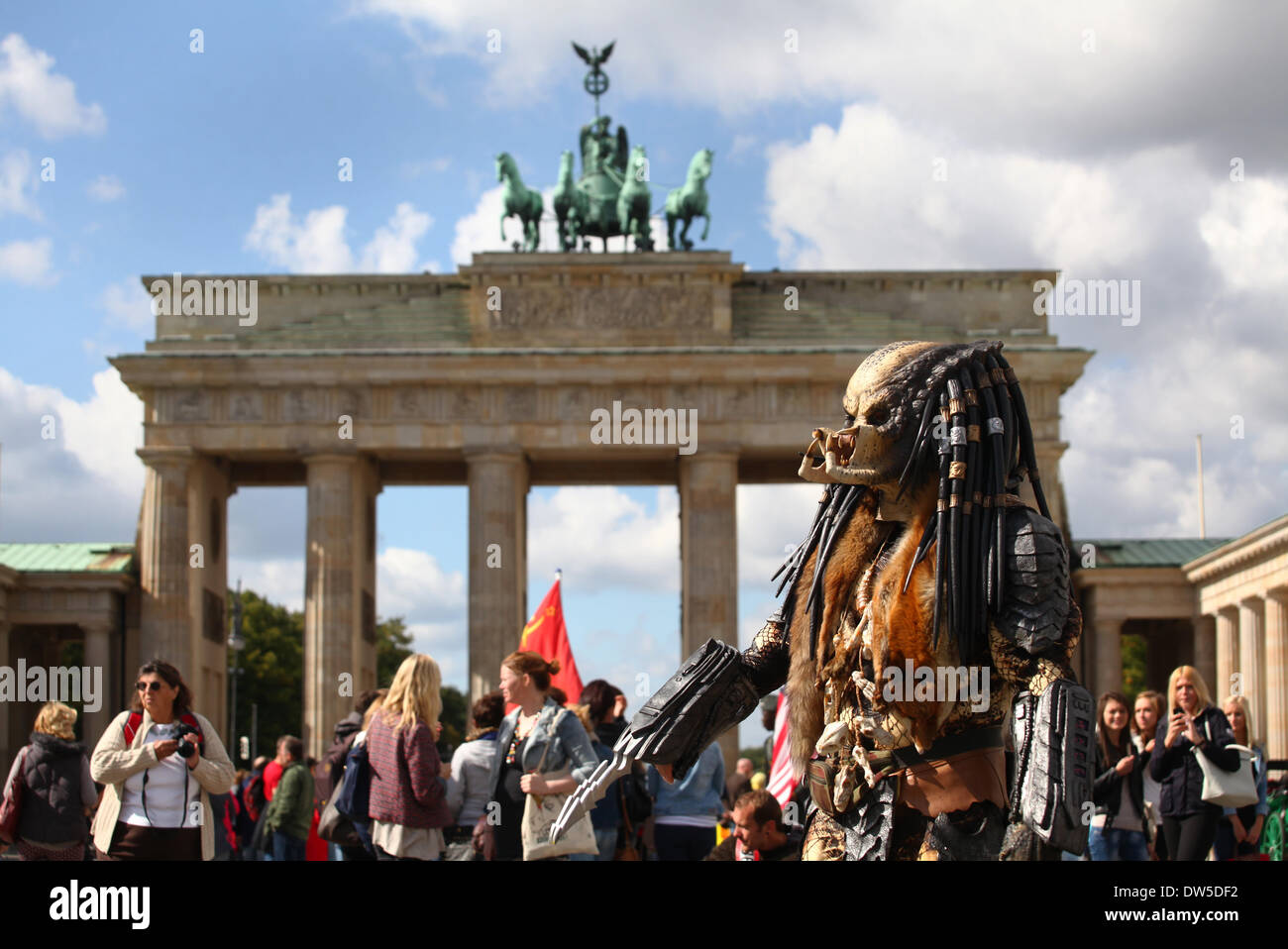 A man dressed up as a monster waits for tourists at the Brandenburg Gate in Berlin, September, 17, 2013. More and more tourists come Berlin. The photo is part of a series on tourism in Berlin. Photo. Wolfram Steinberg dpa Stock Photo