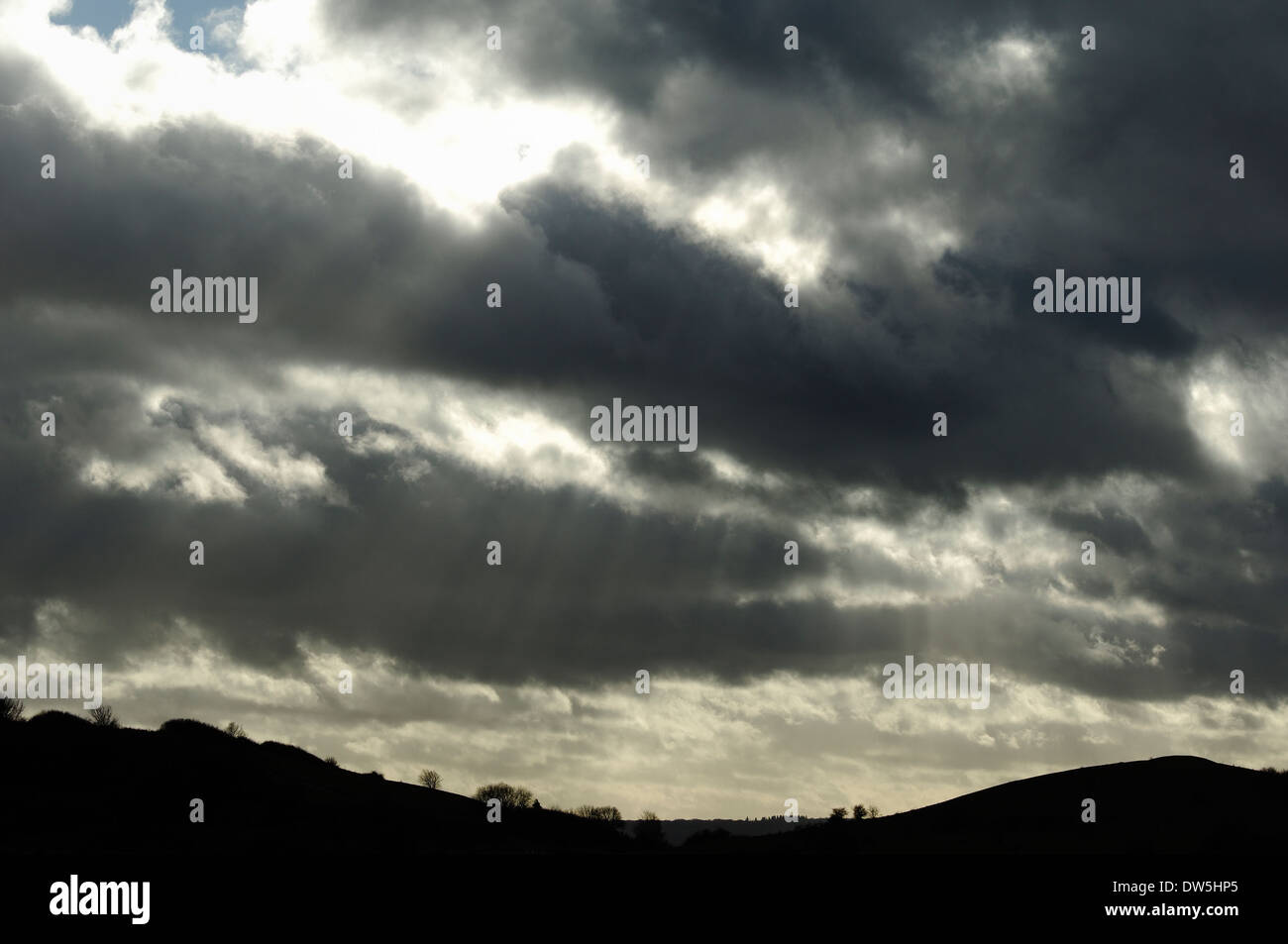 rays of sunshine breaking through rain clouds over Ivinghoe hills, Bedfordshire, England Stock Photo