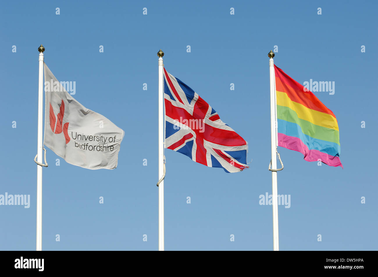 University of Bedfordshire, British Union Jack & Rainbow Flag flutter in the wind Stock Photo