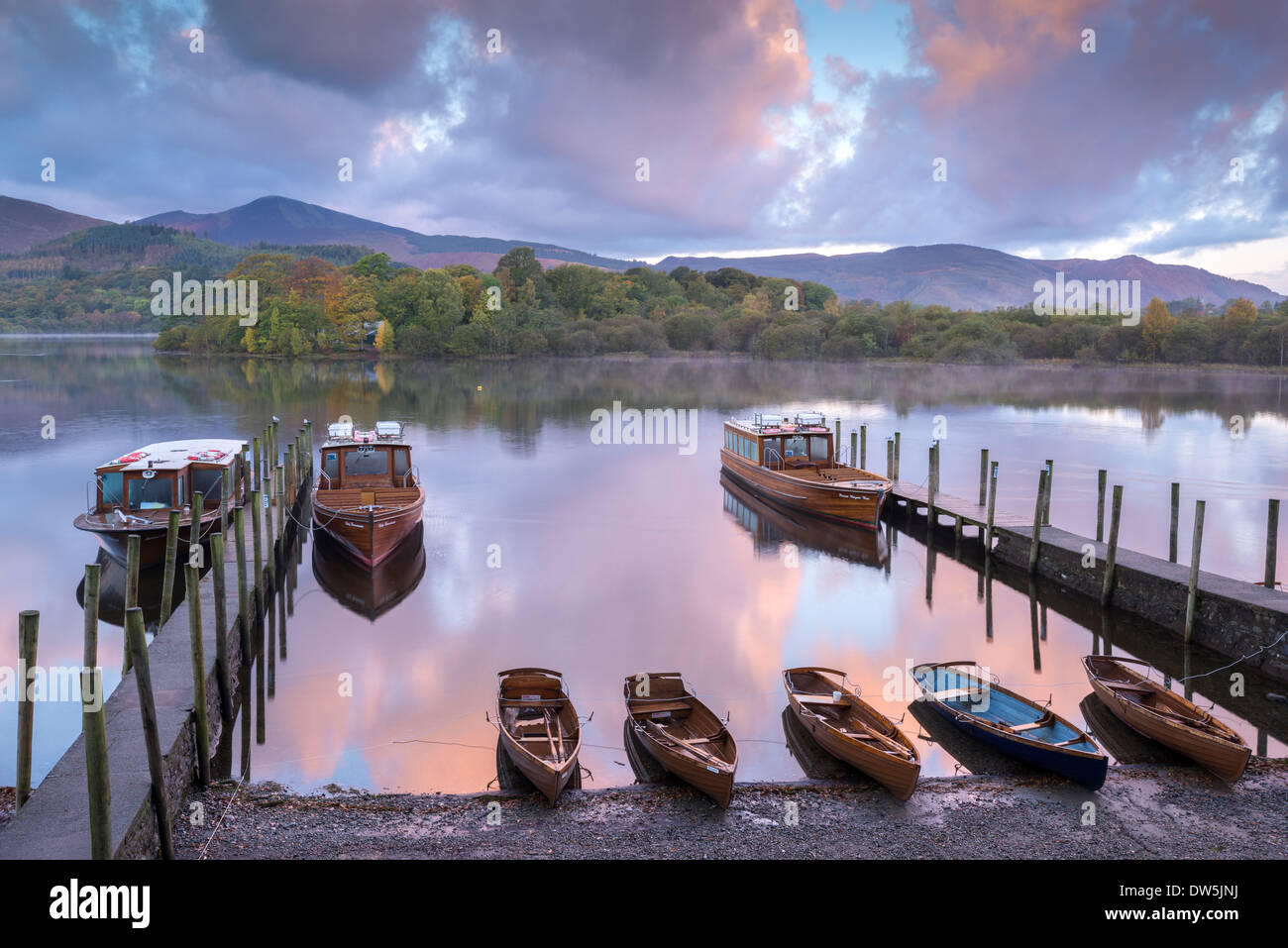 Boats moored on Derwent Water at dawn, Keswick, Lake District, Cumbria, England. Autumn (October) 2012. Stock Photo