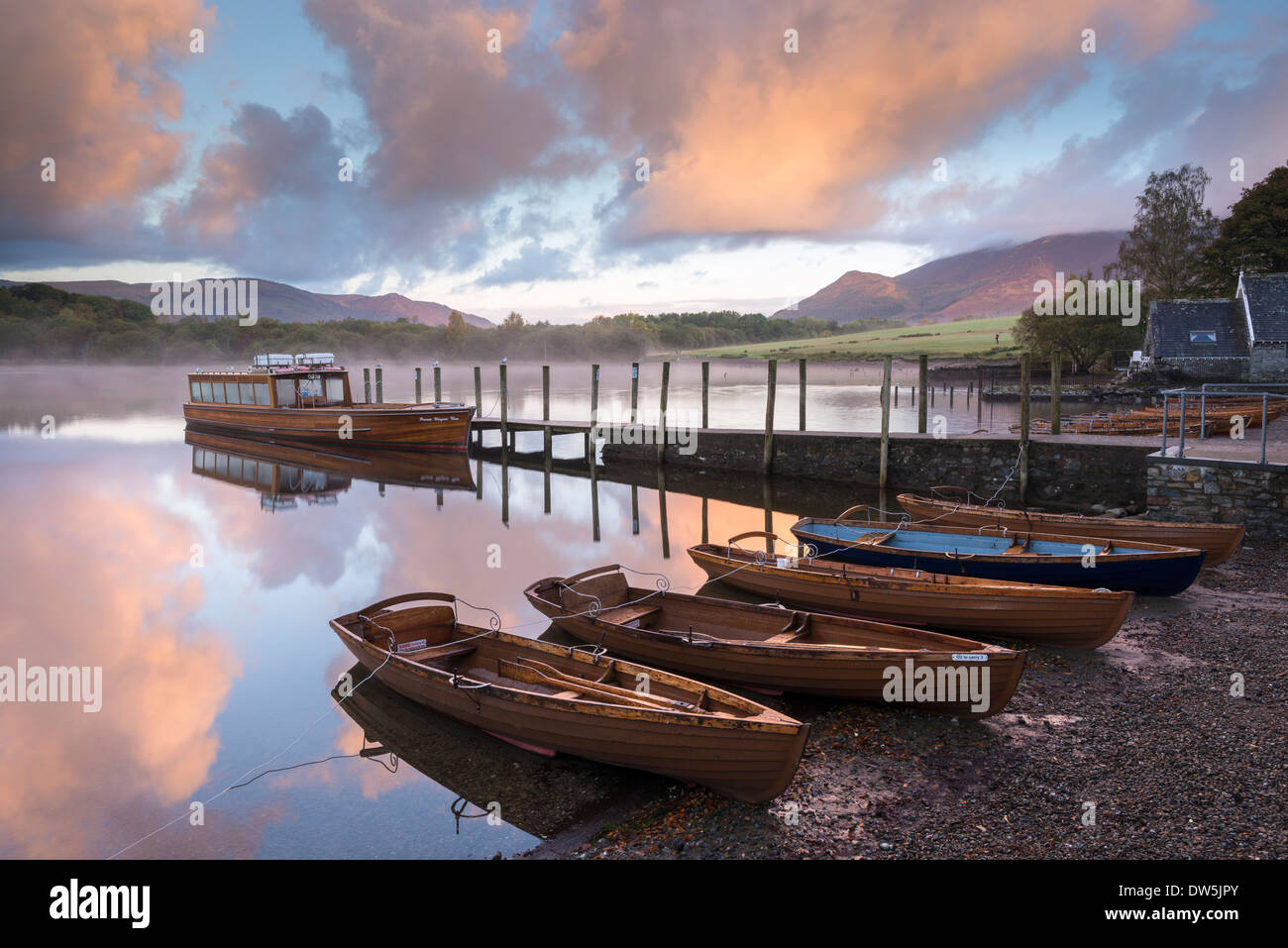 Boats moored on Derwent Water at dawn, Keswick, Lake District, Cumbria, England. Autumn (October) 2012. Stock Photo