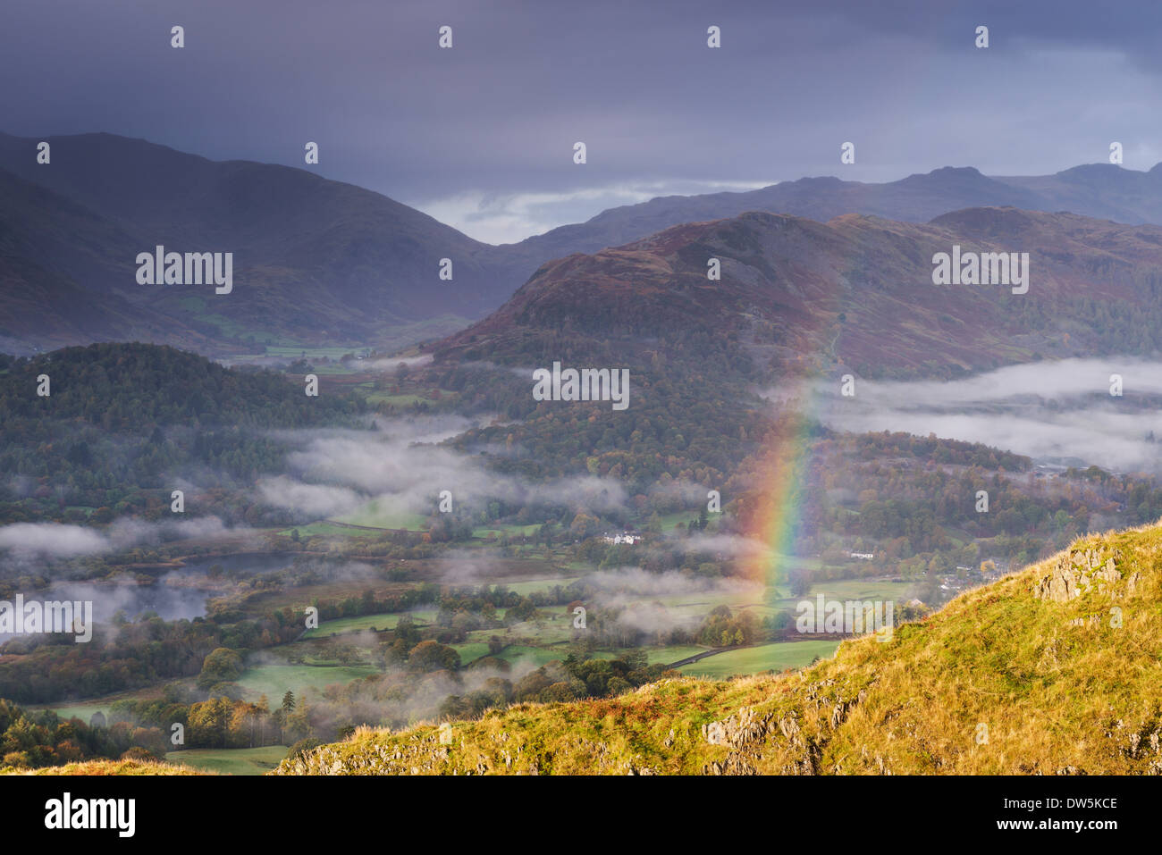Rainbow over mist shrouded landscape, Elterwater, Lake District, Cumbria, England. Autumn (October) 2012. Stock Photo