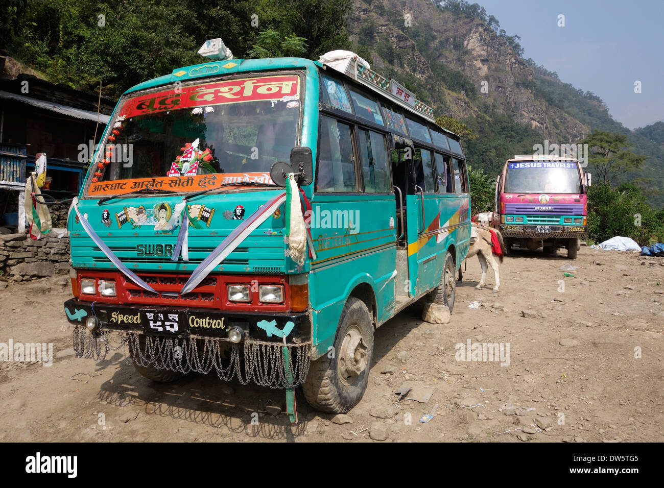 Decorated buses and pack animals in the Gorkha region of Nepal. Stock Photo