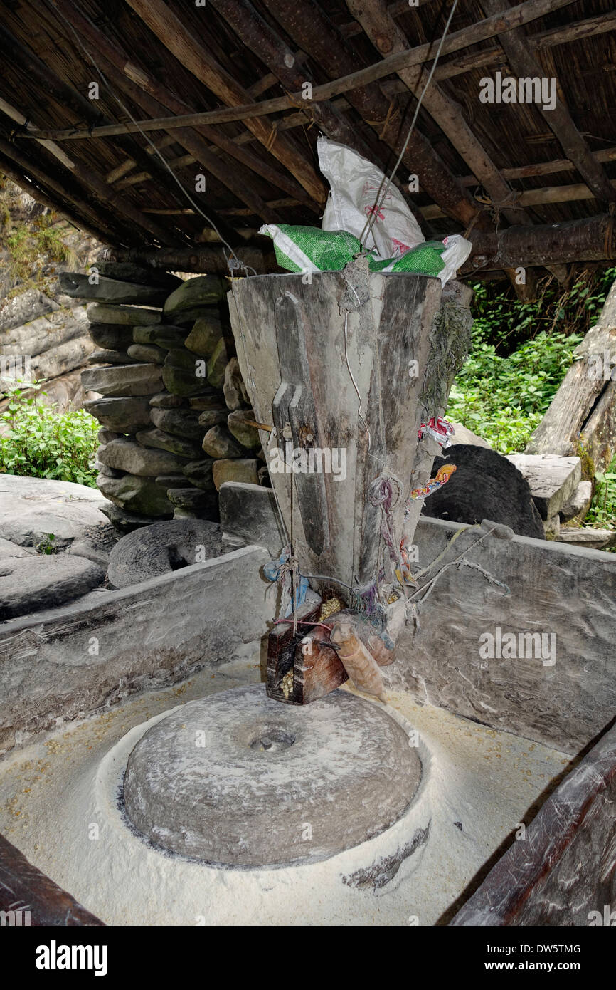 Making corn flour using a water powered grinding mill in the village of Dobhan, Nepal. Stock Photo