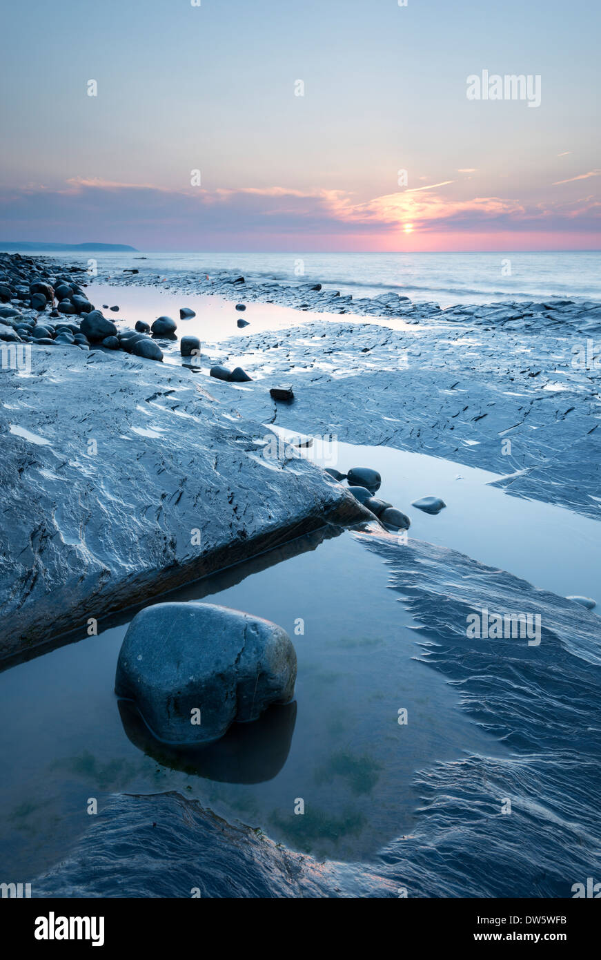 Sunset over the rocky shores of Kilve Beach, Somerset, England. Summer (July) 2013. Stock Photo