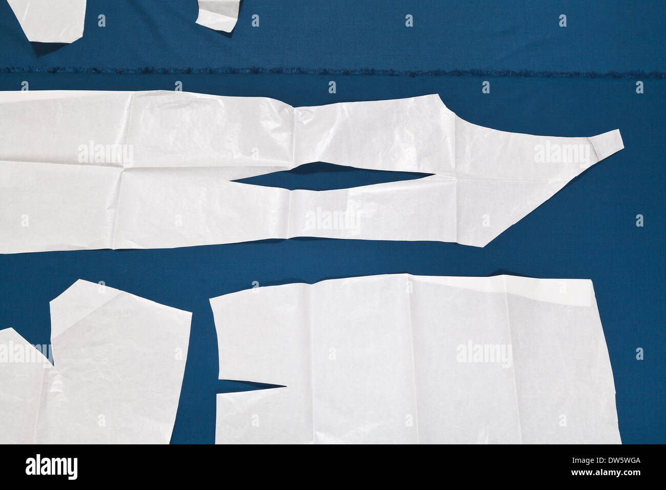 paper model of dress on blue fabric for dress cutting Stock Photo - Alamy