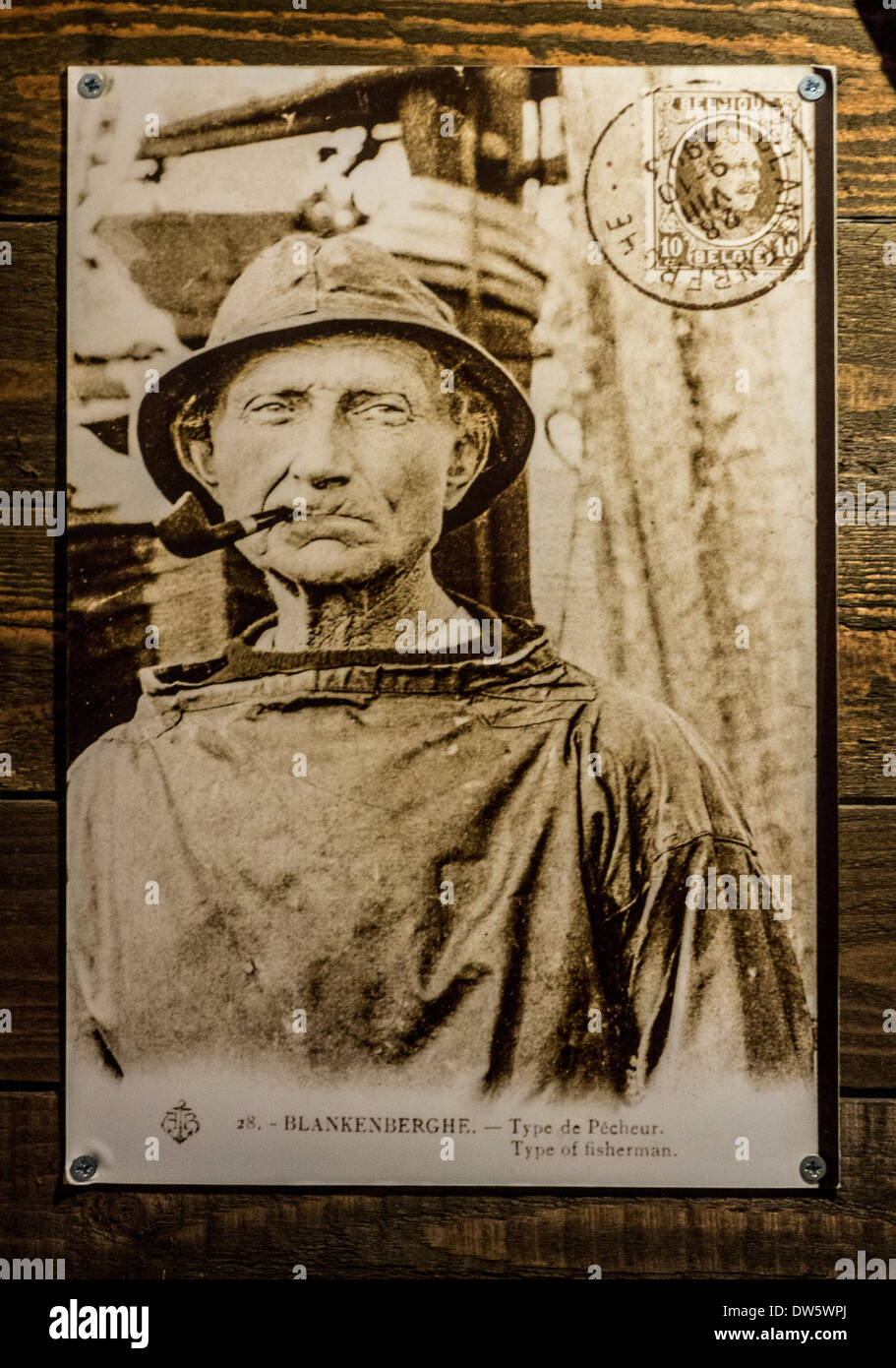 Old archival sepia picture showing close up portrait of fisherman smoking pipe Stock Photo