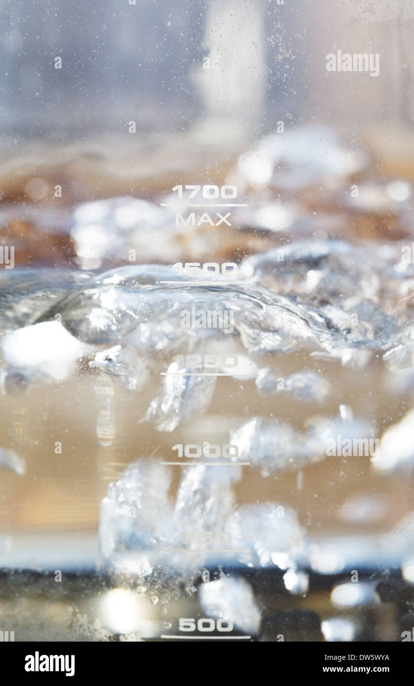 bubbles of boiling water in glass kettle close up Stock Photo