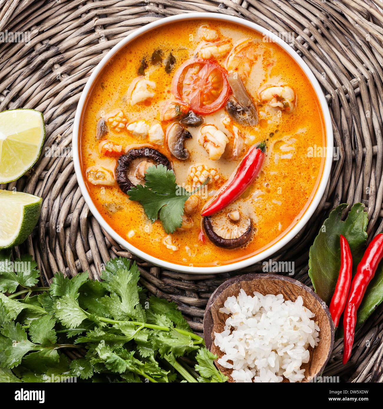Spicy Thai soup Tom Yam with Coconut milk, Chili pepper and Seafood Stock Photo