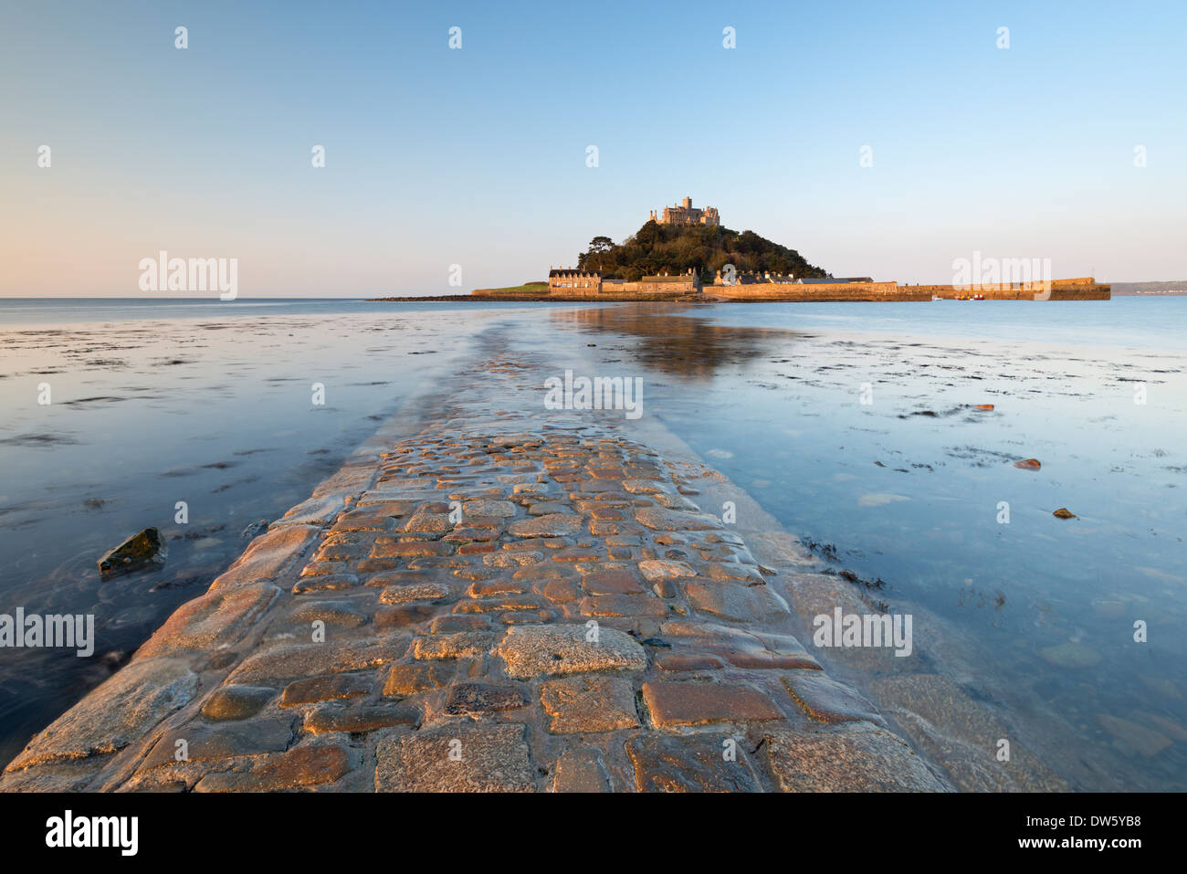 The stone causeway leading to St Michaels Mount in early morning sunshine, Marazion, Cornwall, England. Spring (May) 2013. Stock Photo