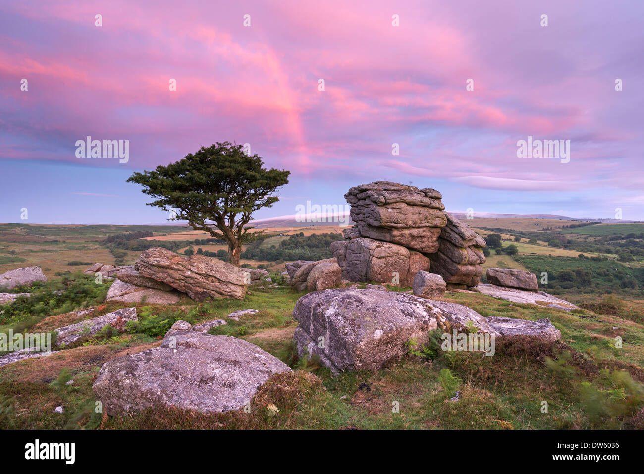 Dawn rainbow above Holwell Tor, Dartmoor, Devon, England. Summer (August) 2013. Stock Photo