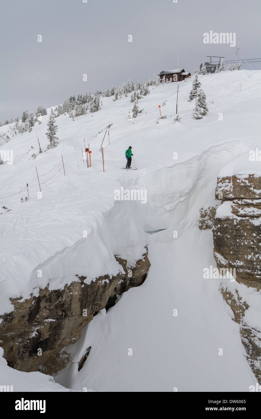 Skier standing on the edge of Corbet's Couloir, Jackson Hole, WY Stock