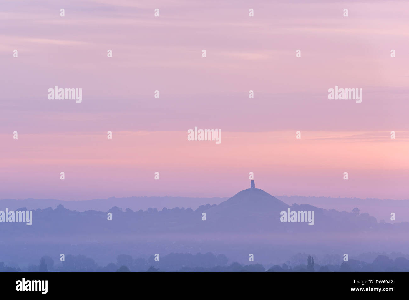 Glastonbury Tor rising surrounded by mist at dawn, Somerset, England. Summer (August) 2013. Stock Photo