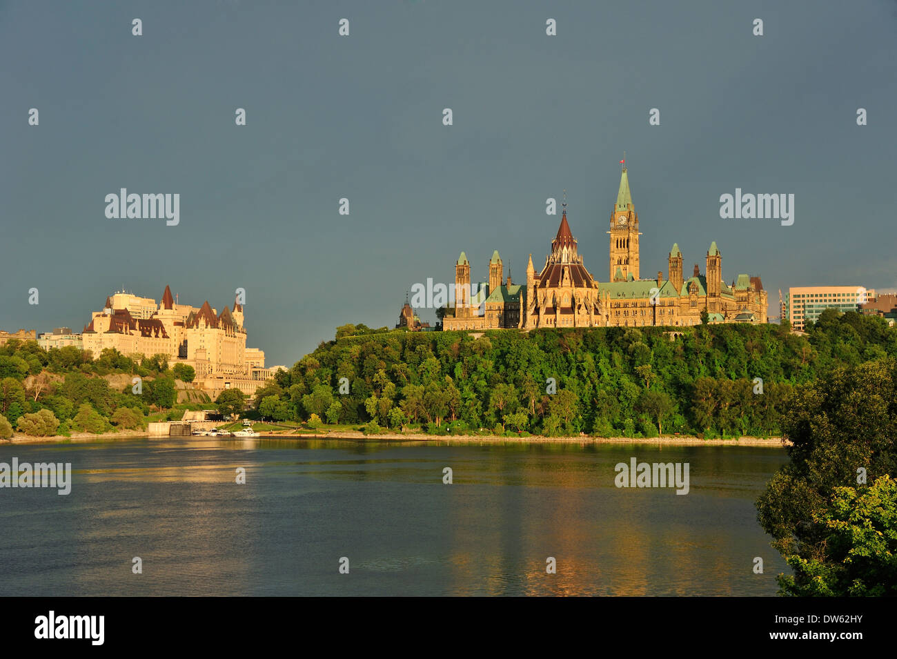 The Canadian parliament buildings, against a stormy sky. The Ottawa River in the foreground. Stock Photo