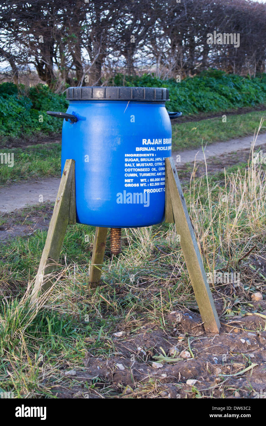 Game bird feeder made from commercial curry sauce barrel. Stock Photo
