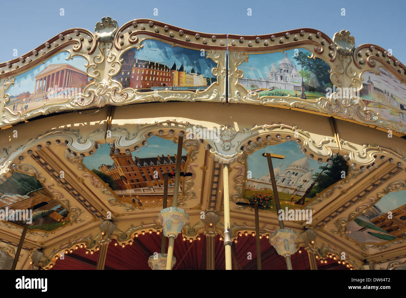a merry-go-round with scenes of Paris painted on it Stock Photo