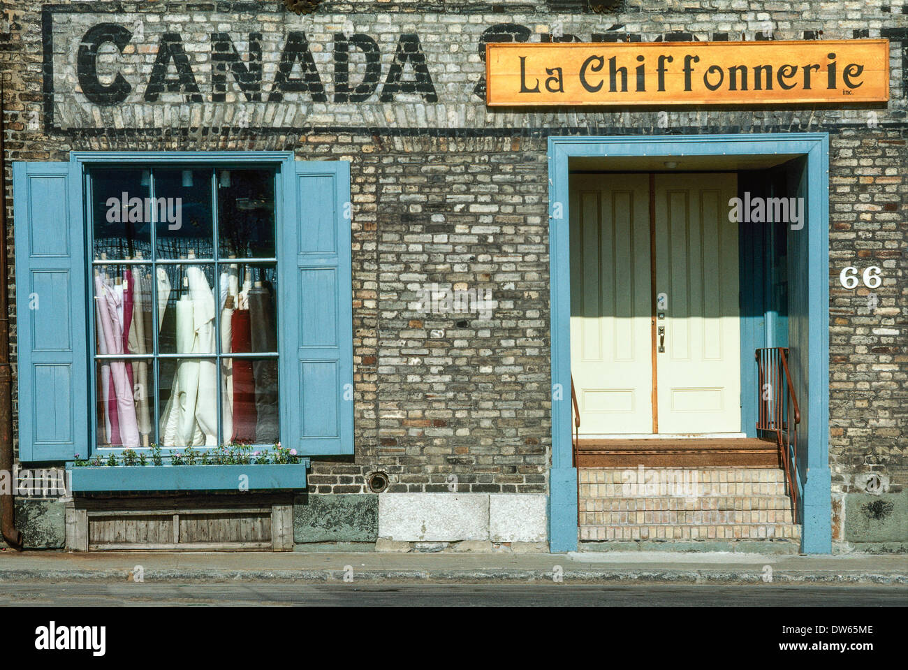 front facade of fabric store in old Quebec City with hand painted sign