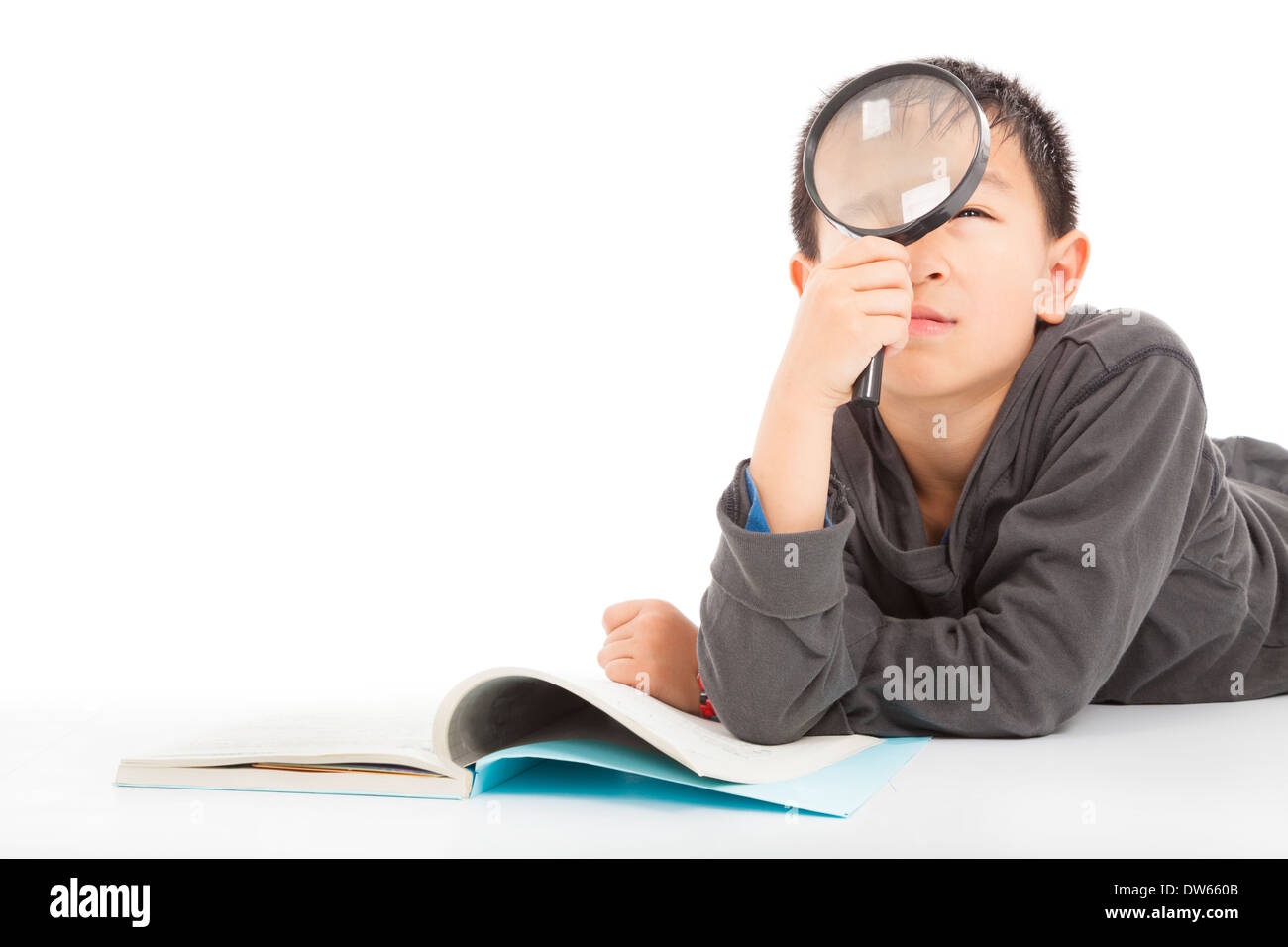 happy kid is holding magnifying glass to explore over white Stock Photo