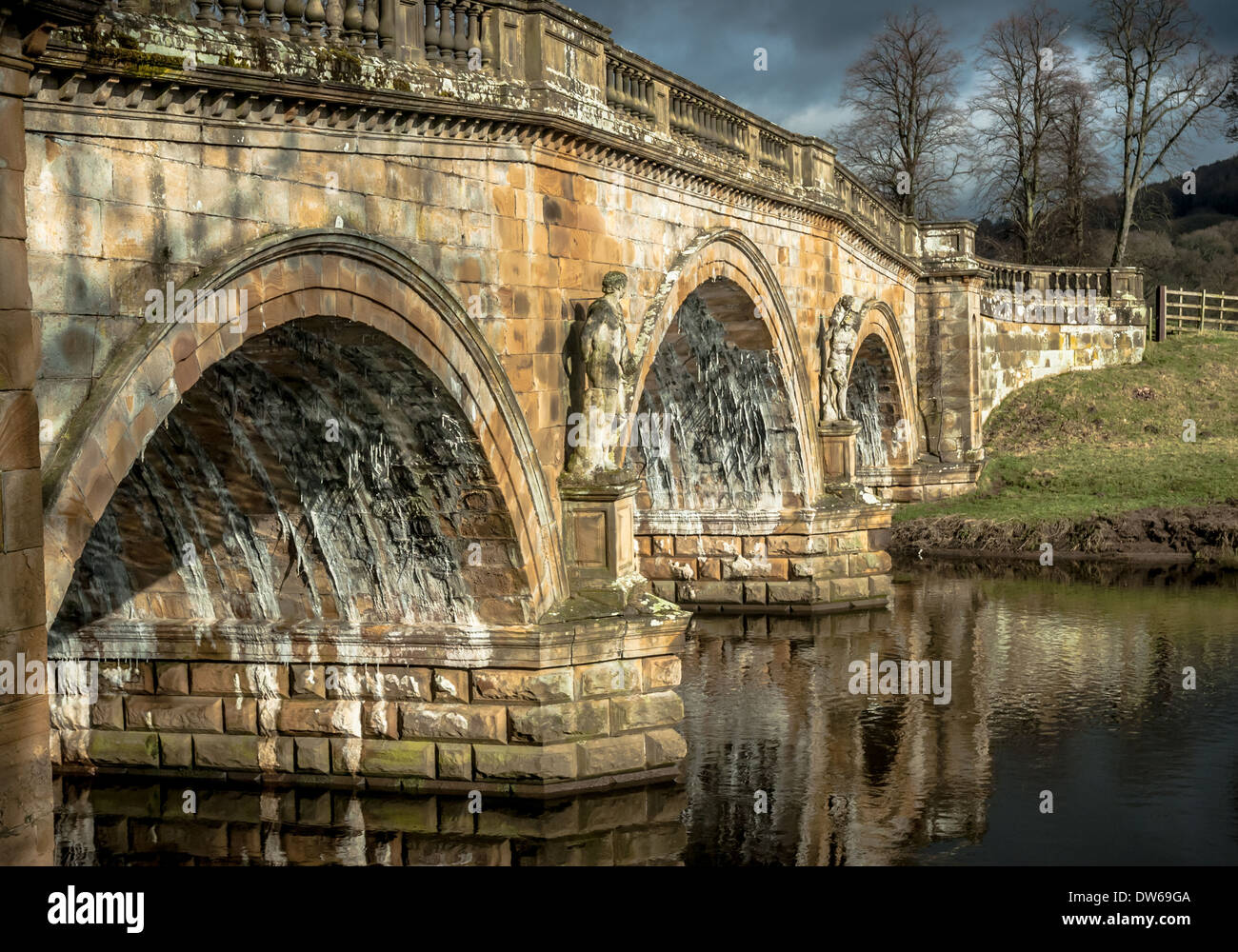 Stone road bridge over the River Derwent at Chatsworth house estate, Derbyshire. Stock Photo