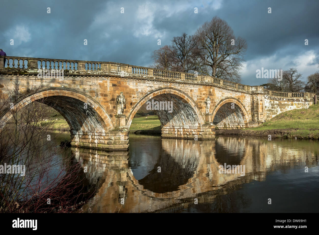 Stone road bridge over the River Derwent at Chatsworth house estate, Derbyshire. Stock Photo