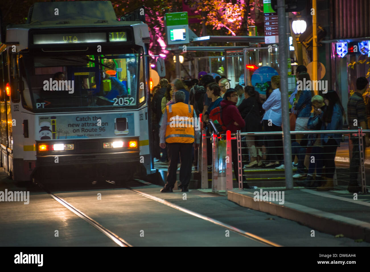 Melbourne tram on Collins street on a busy Saturday night crowd public Stock Photo