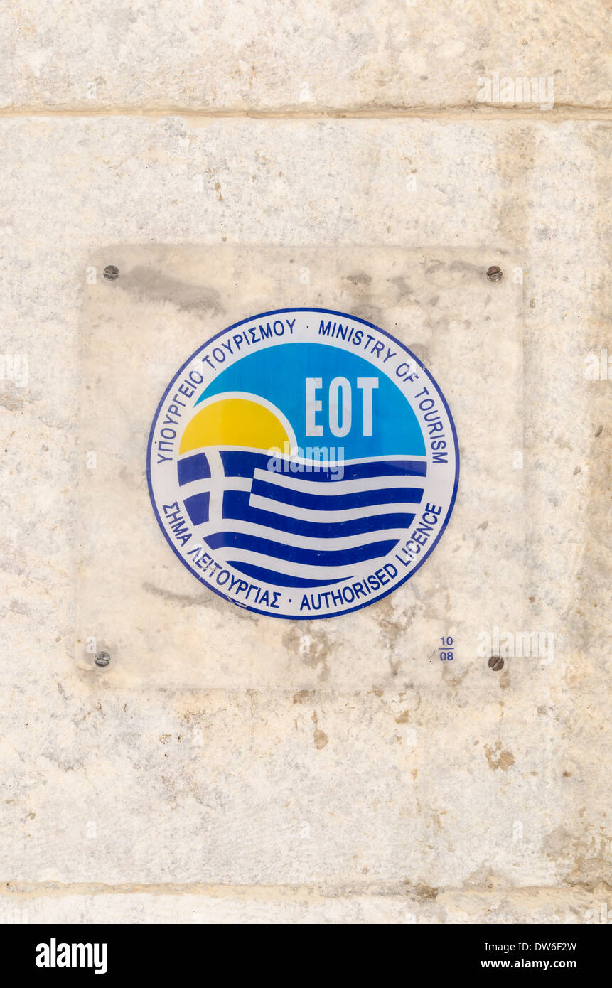 Greek National Tourism Organization (EOT) authorised licence sign on a wall in Syros Town, Greece Stock Photo