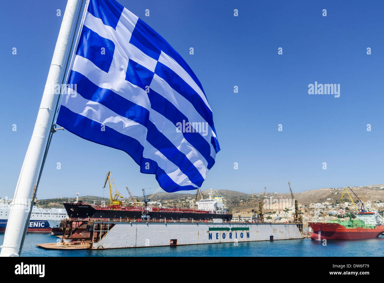 The Greek shipyard of Neorion under a Greek flag on the island of Syros, Greece Stock Photo