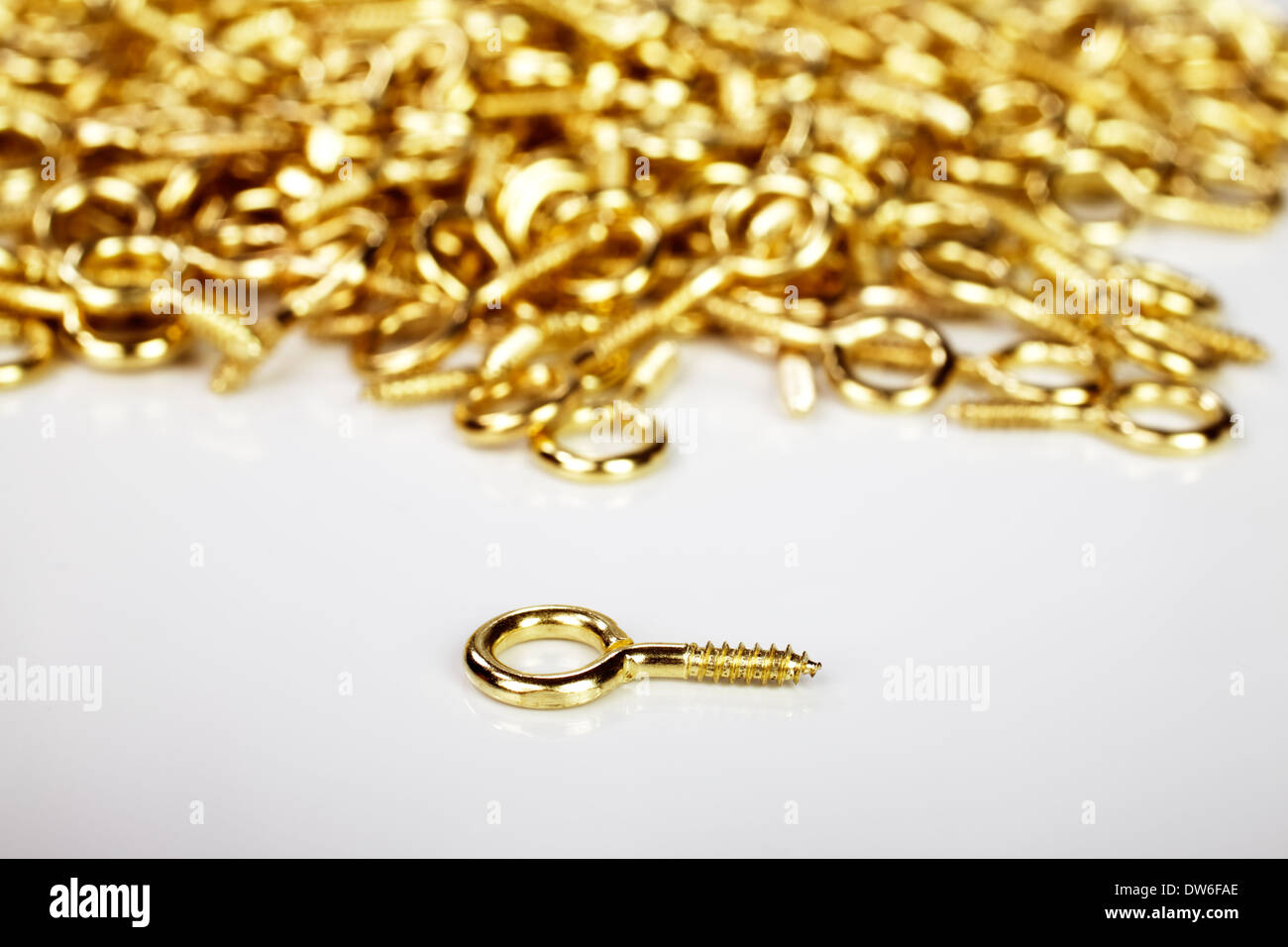 Golden hooks used by framers to stretch a rope on the back of a picture frame on a white background Stock Photo