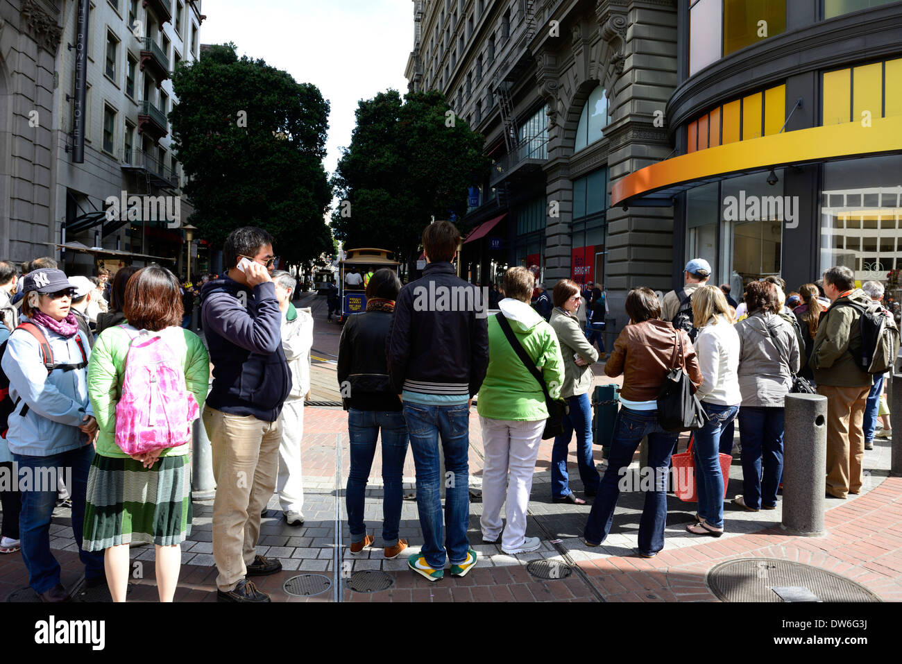 line queue of tourists waiting to board trolley car tourist tourism san francisco california Stock Photo