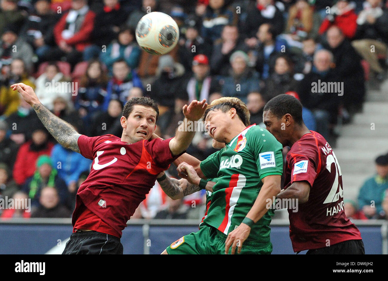 Augsburg's Jeong-Ho Hong (C) and Hanover's Felipe (L) and Marcelo vie for the ball during the Bundesliga soccer match FC Augsburg vs Hanover 96 at SGL-Arena in Augsburg', Germany, 01 March 2014. The match ended 1-1. Photo: Stefan Puchner/dpa (ATTENTION: Due to the accreditation guidelines, the DFL only permits the publication and utilisation of up to 15 pictures per match on the internet and in online media during the match.) Stock Photo