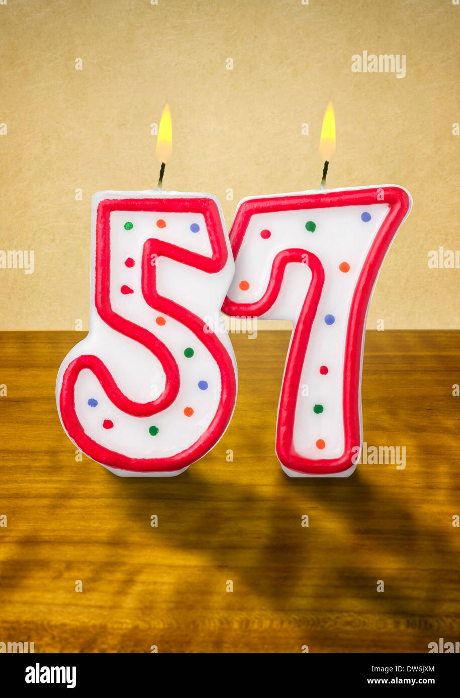 Burning birthday candles number 57 Stock Photo - Alamy