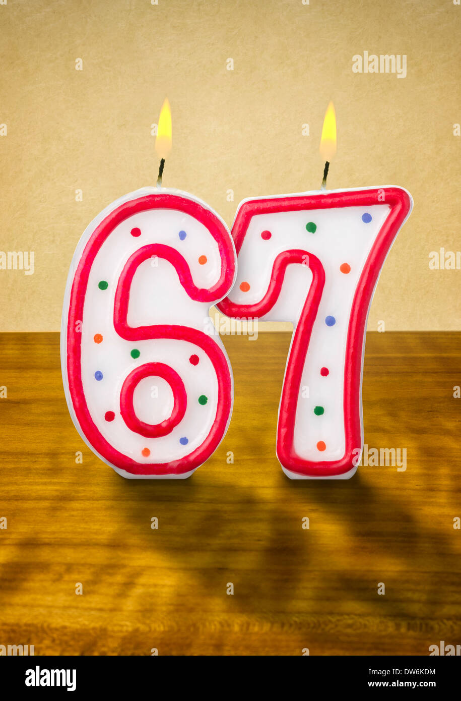 Burning birthday candles number 67 Stock Photo - Alamy