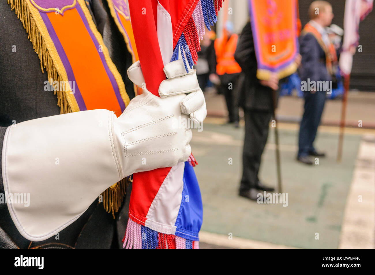 Belfast, Northern Ireland. 1st March 2014 - An Orangeman wears ceremonial gloves and holds a Union Flag. Stock Photo
