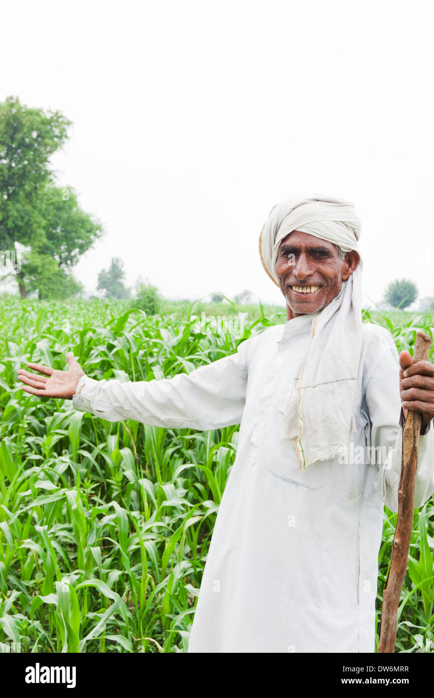 1 Indian farmer standing and showing farms Stock Photo - Alamy